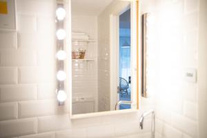 a bathroom with a mirror and a sink at Nature Escape in Lahemaa Bright 1-Bedroom Apartment with Terrace in Kolga +22 photos