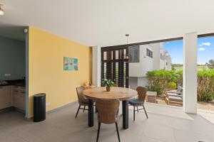 a kitchen and dining room with a table and chairs at New bungalow 466 Blue Bay in Blue Bay