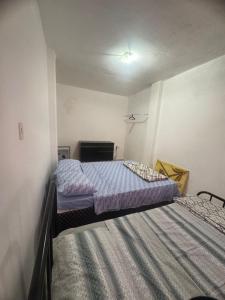 a bedroom with two beds and a fireplace at Quarto no Coração de Valença in Valença
