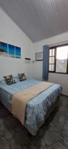 Un dormitorio con una cama en una habitación con ventana. en Brachil 2, en Búzios
