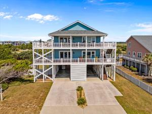 an aerial view of a blue house with a balcony at Sunny Second Row Beach and BIG views in Varnamtown