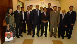 a group of men in suits posing for a picture at The Enterprise in Karachi