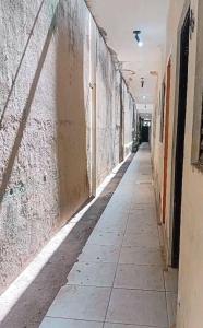 an empty hallway of an old building with a sidewalk at Centro - Praia de Iracema - Pousada Panorama do Mar in Fortaleza