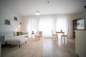 a living room with a couch and a table at Nature Escape in Lahemaa Bright 1-Bedroom Apartment with Terrace in Kolga