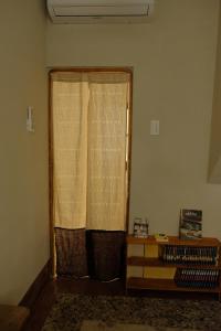 a living room with two curtains and a table at Tomo 伴 in Tainan