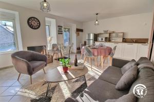 a living room with a couch and a table at Le gite de marie in Monterblanc