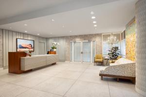 a living room with a bed and a couch at Hotel Continental Miami Beach, Tapestry Collection by Hilton in Miami Beach