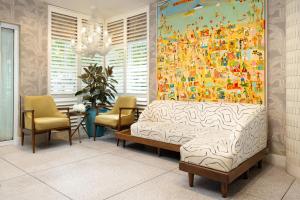 a bedroom with a large painting on the wall at Hotel Continental Miami Beach, Tapestry Collection by Hilton in Miami Beach +38 photos