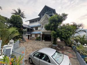 a car parked in front of a house at Munnar Blue Mist in Munnar