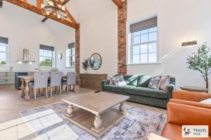 a living room with a couch and a table at The Old Chapel in Dilhorne