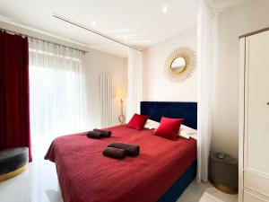 a bedroom with a large red bed with red pillows at Romantica SPA Kraków in Kraków