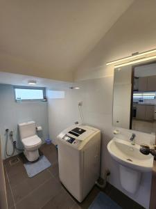 a bathroom with a toilet and a sink at The Ultimate Escape in Negombo