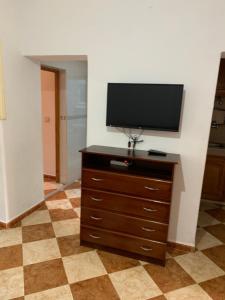a flat screen tv on a dresser in a room at Zellaka apartamento2 in Asilah