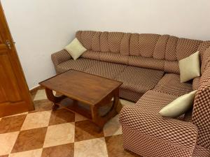 a living room with a couch and a coffee table at Zellaka apartamento2 in Asilah