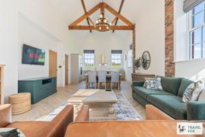 a living room with a couch and a table at The Old Chapel in Dilhorne