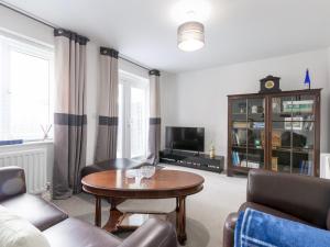 a living room with a couch and a table at Pass the Keys Modern Office Driveway Near Crok Durham in Willington