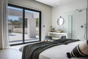 スパルティアにあるAlena by Vintage Travelの大きなベッドと大きな窓のある寝室 +24枚の写真