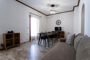 a living room with a couch and a table at Tasos Apartment in Leonidio