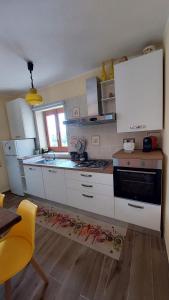 a kitchen with white cabinets and a stove top oven at Casa Zia Maria 6 posti Monterosso Coast to Coast in Monterosso