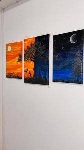 a group of paintings hanging on a wall at Hostel Koral in Szczecin