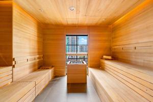 a sauna with wooden walls and a window at Stylish Studio with City Views & Free Parking in Miami