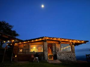 a house with lights on it at night at Aldea Lea Tapalpa in Barranca del Refugio