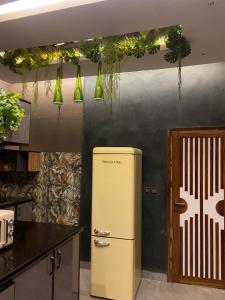 an old refrigerator in a kitchen with a door at Maison Rose Ngaparou in Ngaparou