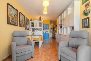 a kitchen and dining room with two chairs and a table at Artcorner, POOL & WIFI in Costa Del Silencio