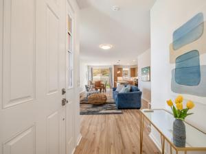 a living room with a white door and a blue couch at Kalo Homes - Surfside Serenity in Makaha Valley +77 photos