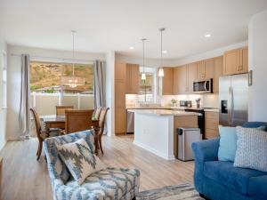a kitchen and living room with a blue couch at Kalo Homes - Surfside Serenity in Makaha Valley