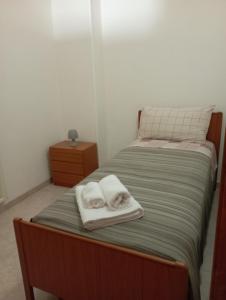 a bedroom with a bed with two towels on it at Casa Checco in Cisternino