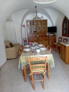 a dining room with a table and a couch at Casa Checco in Cisternino