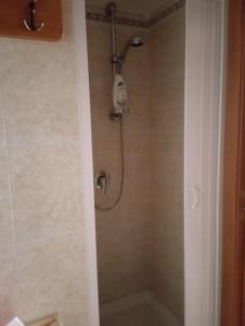 a shower with a shower head in a bathroom at Casa Checco in Cisternino +5 photos