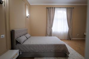 a small bedroom with a bed and a window at Citadelle house in Alba Iulia