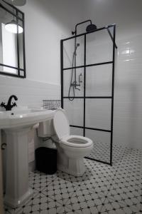 a white bathroom with a toilet and a sink at Citadelle house in Alba Iulia +26 photos