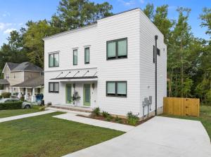 a white house with green doors and windows at On Cloud Durham Unit B in Durham