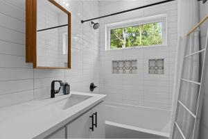 a white bathroom with a sink and a shower at On Cloud Durham Unit B in Durham +28 photos