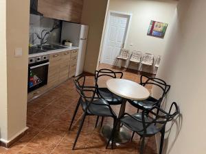 a kitchen with a table and chairs in a kitchen at Open Door Hostel in Tirana +25 photos