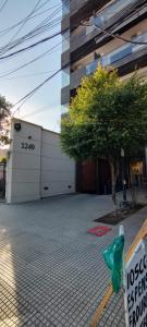 a building with a sign on the side of a street at Departamento Temporario Tucuman 3Personas Pileta in San Miguel de Tucumán