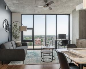 a living room with a couch and a table at Modern 2BR Gem Rooftop Pool and Workspaces in Birmingham