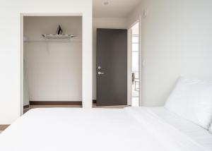 a bedroom with a white bed and a black door at Modern 2BR Gem Rooftop Pool and Workspaces in Birmingham +6 photos