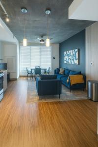 a living room with a blue couch and a table at Birmingham Stay 2BR with Rooftop Amenities in Birmingham