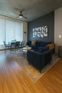a living room with a couch and a table at Birmingham Stay 2BR with Rooftop Amenities in Birmingham