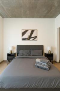 a bedroom with a large bed with two night stands at Birmingham Stay 2BR with Rooftop Amenities in Birmingham +14 photos