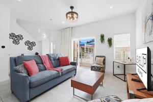 a living room with a couch and a table at Direct resort access Balcony Pool Upgraded Inside in Kissimmee