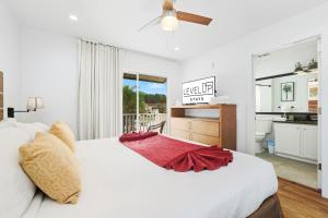 a bedroom with a white bed and a bathroom at Direct resort access Balcony Pool Upgraded Inside in Kissimmee +44 photos