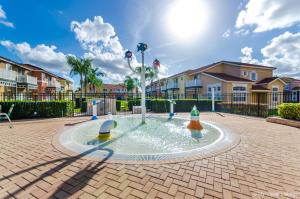 a fountain in the middle of a courtyard with houses at Direct resort access Balcony Pool Upgraded Inside in Kissimmee