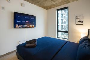 a bedroom with a large blue bed and a window at Bright 2BR Apt Pool, Gym Walkable Area in Birmingham