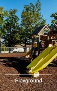 a playground with a slide in a park at Luxury Studio Condo With Beautiful Lake View in Radical