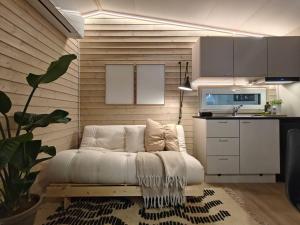 a living room with a white couch in a kitchen at Yllas Cabin for Work, Ski and Relax in Ylläsjärvi